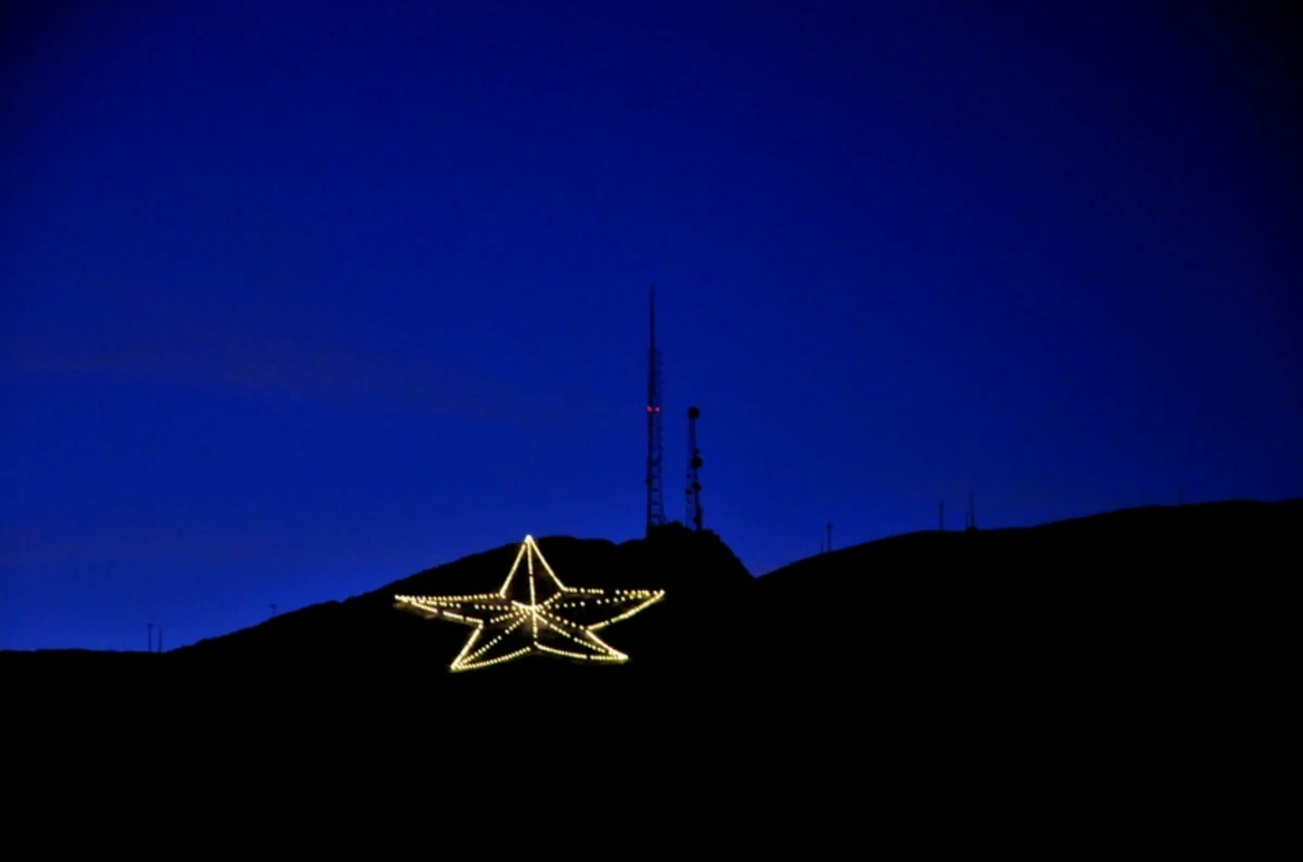 The Star on the Mountain lit at dusk on the Franklin Mountains above El Paso